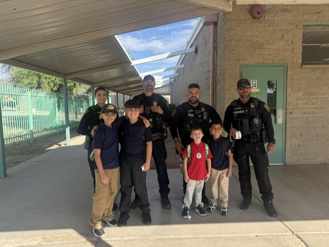Students pose with Tucson Police officers